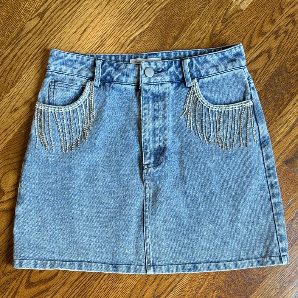 Denim Mini Skirt with Rhinestone Fringe Detail on front pockets